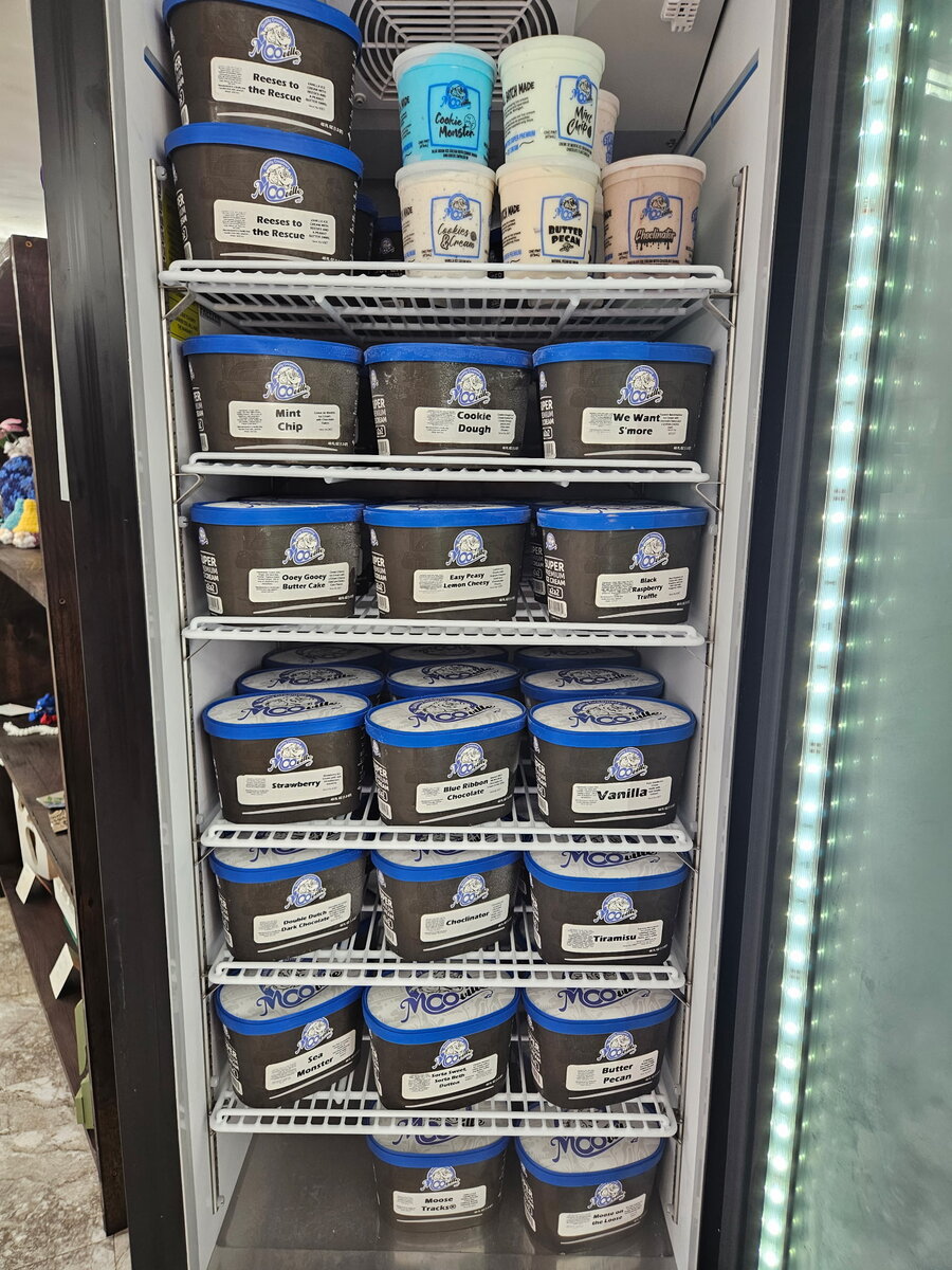 Freezer full of MooVille ice cream tubs in flavors like tiramisu and cookie dough