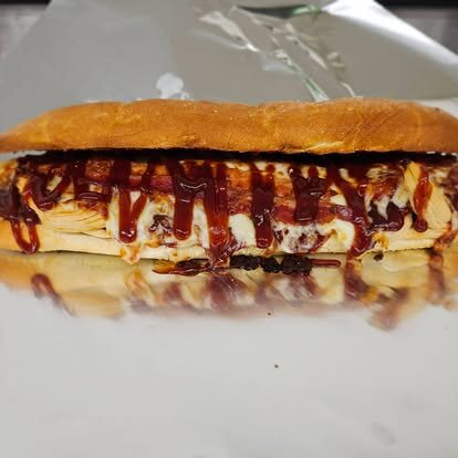 BBQ chicken sub drizzled with barbecue sauce