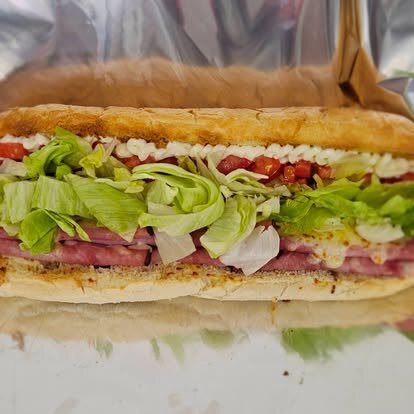 Italian sub loaded with salami, lettuce, tomato and onion
